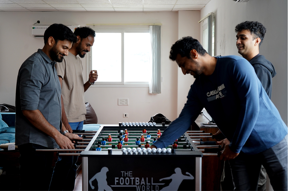 The CloudFiles team playing foosball together in the office
